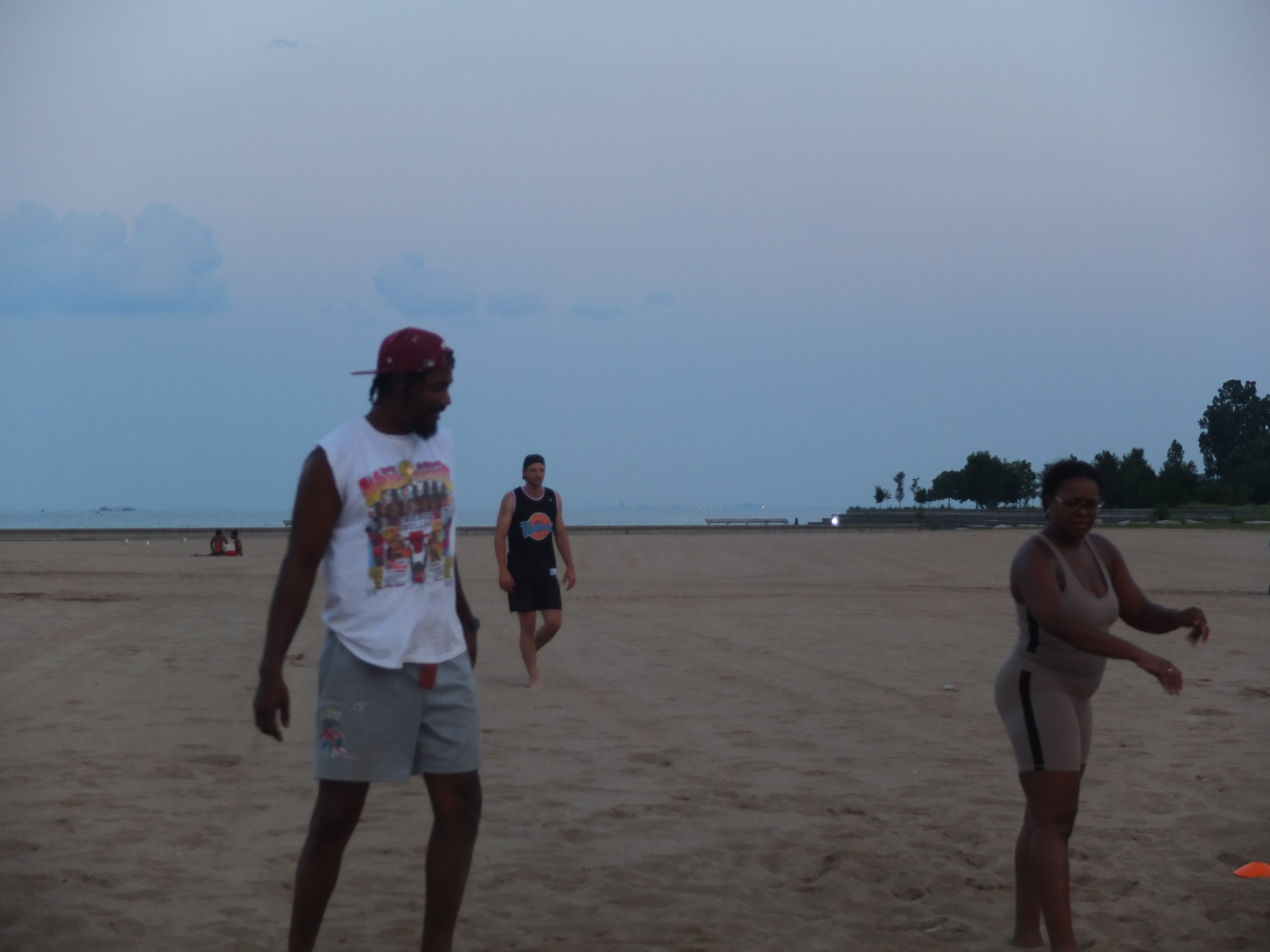Three players relaxing on sand